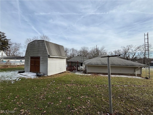 view of side of home featuring a storage unit and a yard