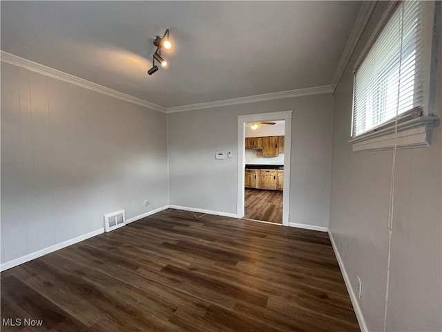 unfurnished room featuring ceiling fan, ornamental molding, dark hardwood / wood-style floors, and rail lighting