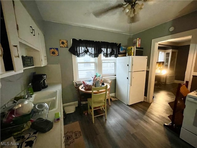 dining area with dark hardwood / wood-style flooring, sink, and ceiling fan