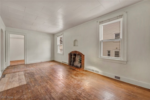 unfurnished living room with wood-type flooring and a fireplace