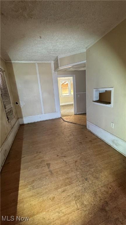 interior space featuring wood-type flooring and a textured ceiling