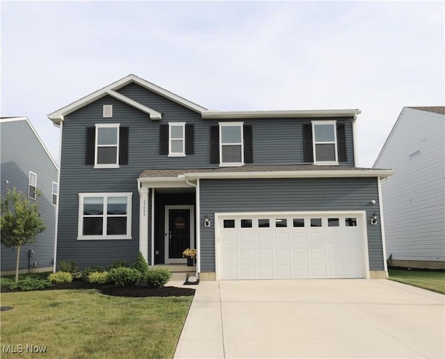 view of front property with a garage and a front lawn