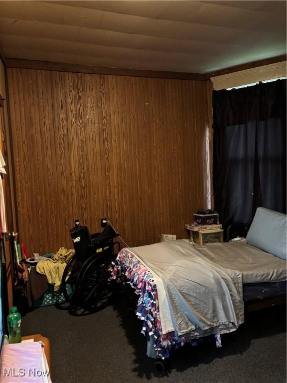 428 Foster Ave, Cambridge, OH 43725 - carpeted bedroom featuring wooden walls and wooden ceiling