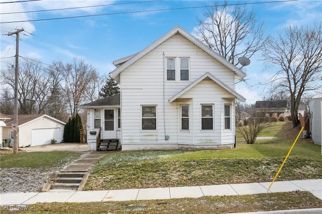 bungalow with a garage, an outdoor structure, and a front lawn