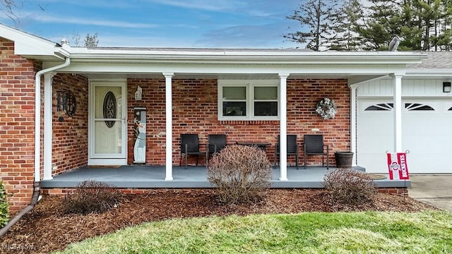 property entrance with covered porch and a garage