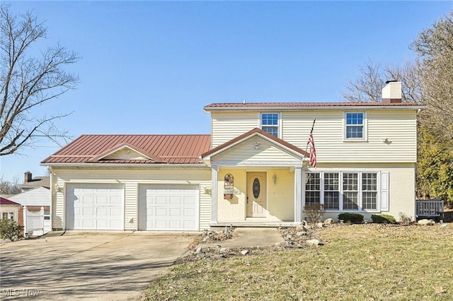 view of front of property with a garage and a front yard