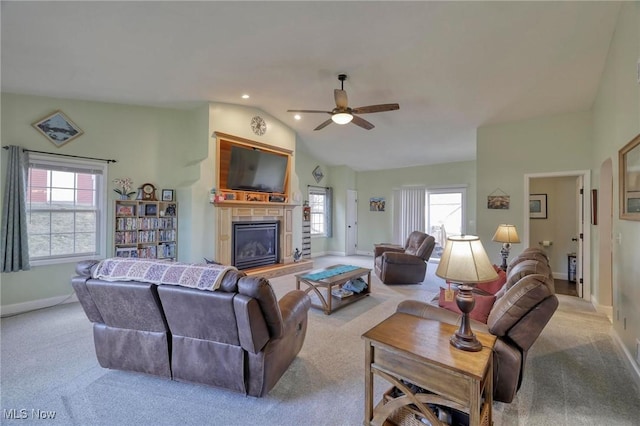 living room with vaulted ceiling, ceiling fan, and light colored carpet