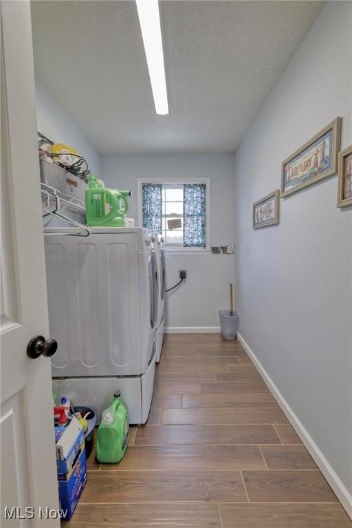 laundry area featuring hardwood / wood-style flooring and washer and clothes dryer