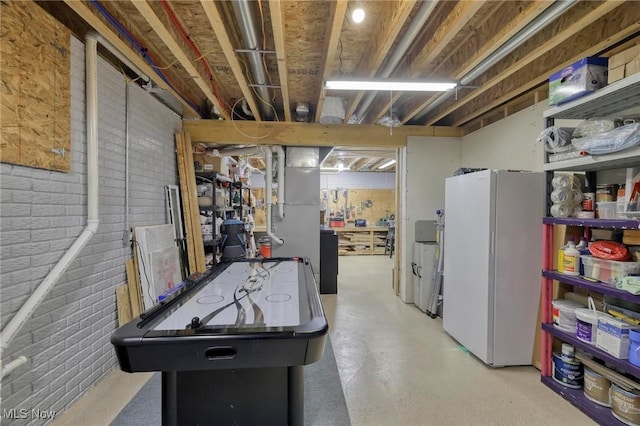 recreation room with brick wall