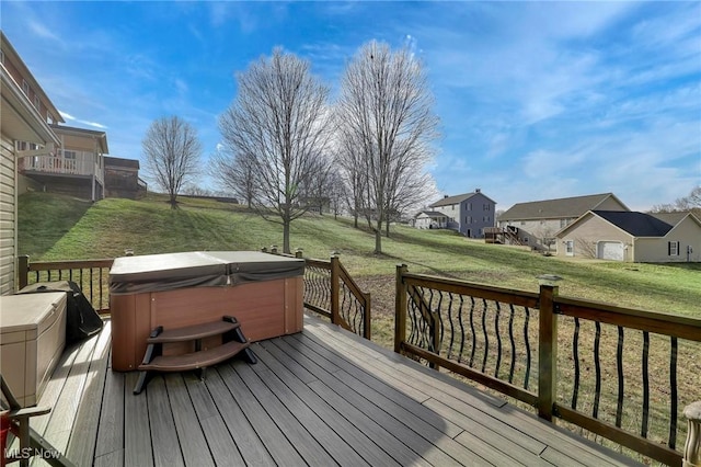 wooden terrace with a lawn and a hot tub