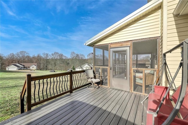 deck featuring a lawn and a sunroom