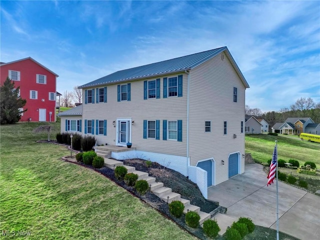 view of front of property featuring a front yard and a garage