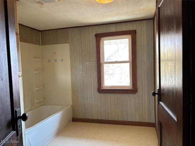 bathroom featuring shower / bathtub combination and a textured ceiling