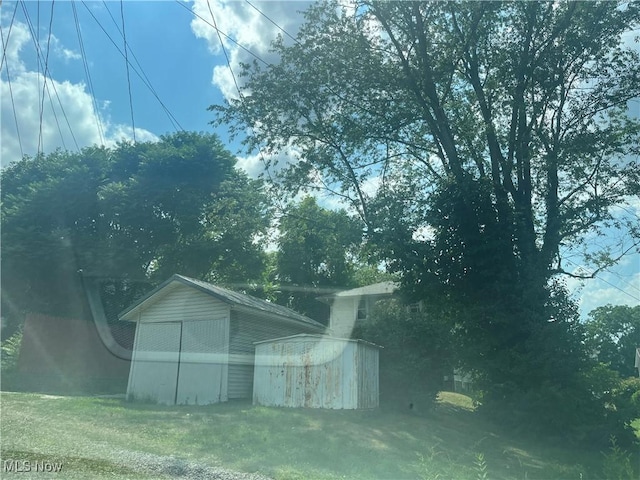 view of outbuilding featuring a yard