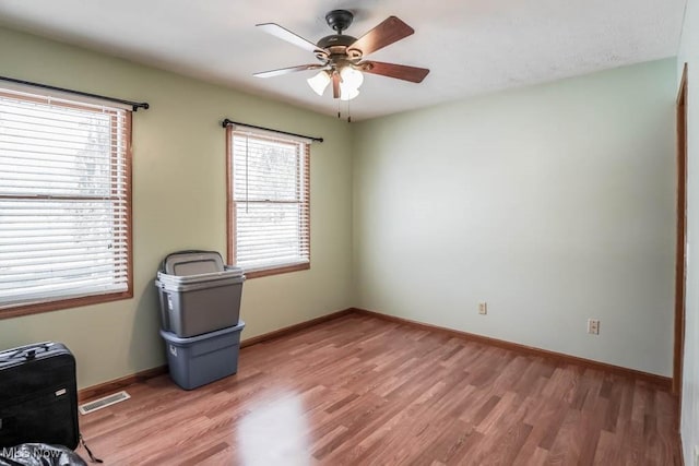 spare room with ceiling fan and light hardwood / wood-style floors