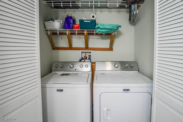 clothes washing area featuring separate washer and dryer