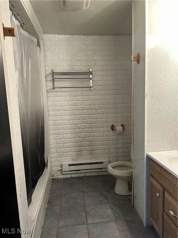 bathroom featuring baseboard heating, vanity, a shower with curtain, and toilet