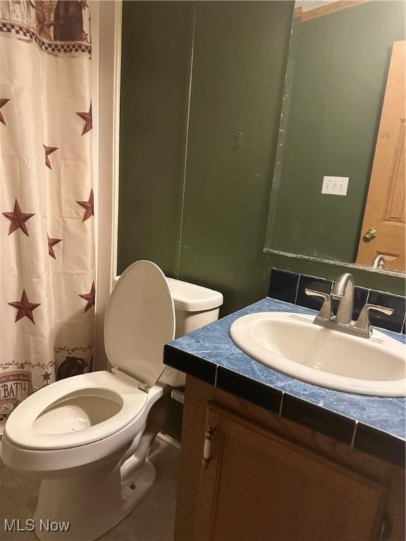 bathroom featuring vanity and toilet