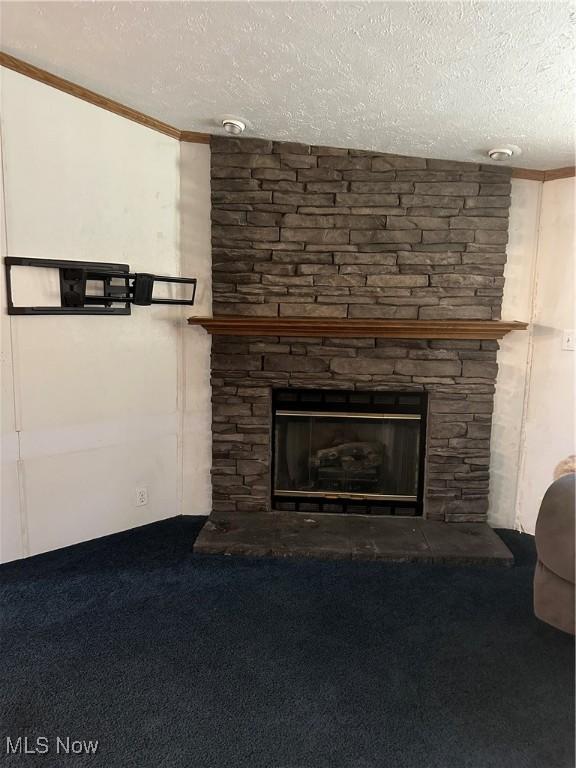 room details with carpet flooring, a stone fireplace, and a textured ceiling