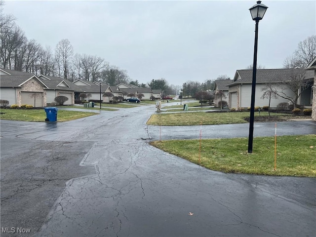 6695 Clingan Rd Unit 26, Poland, OH 44514 - view of asphalt road with street lighting and a residential view