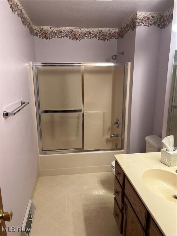 6695 Clingan Rd Unit 26, Poland, OH 44514 - bathroom with toilet, vanity, shower / bath combination with glass door, and tile patterned floors