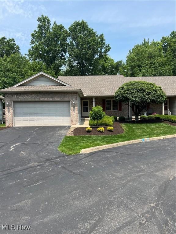 6695 Clingan Rd Unit 26, Poland, OH 44514 - single story home featuring driveway, an attached garage, brick siding, and a front yard