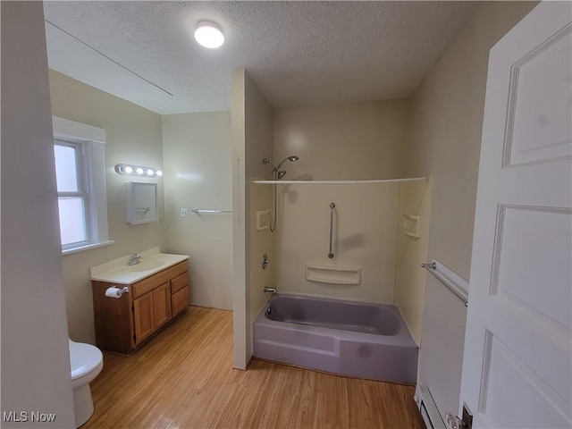 full bathroom featuring wood finished floors, toilet, a textured ceiling, vanity, and shower / tub combination