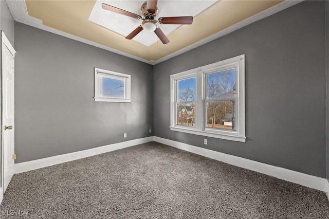 spare room with ceiling fan and carpet