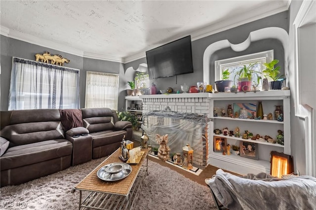 living room with ornamental molding, a fireplace, carpet, and a textured ceiling