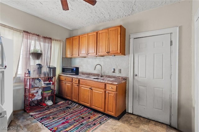 kitchen with tasteful backsplash, sink, a textured ceiling, and ceiling fan