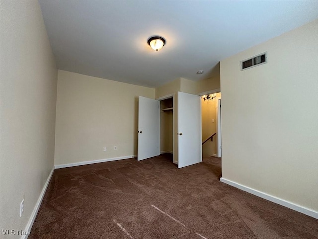 unfurnished bedroom featuring dark carpet