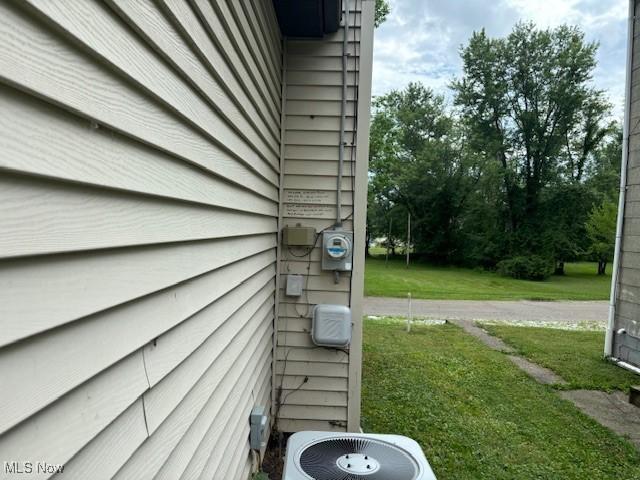 view of property exterior featuring a yard and central air condition unit