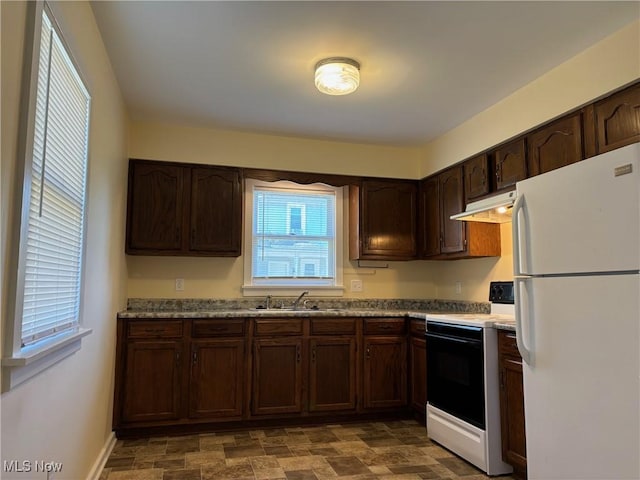 kitchen featuring sink, white fridge, electric range, light stone countertops, and dark brown cabinets