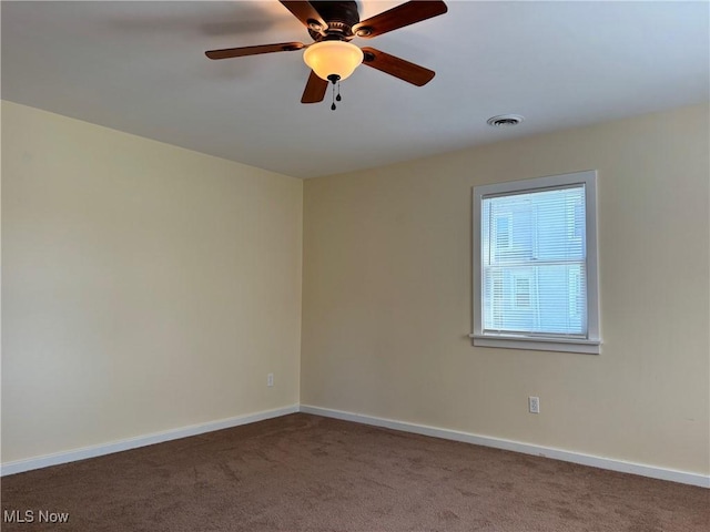 unfurnished room featuring ceiling fan and carpet