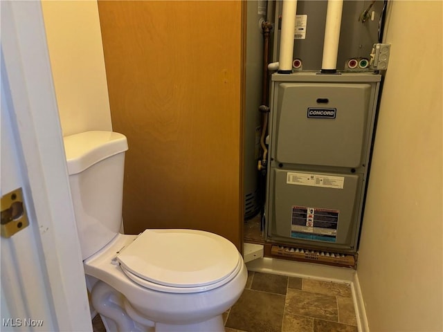 bathroom with toilet and heating unit