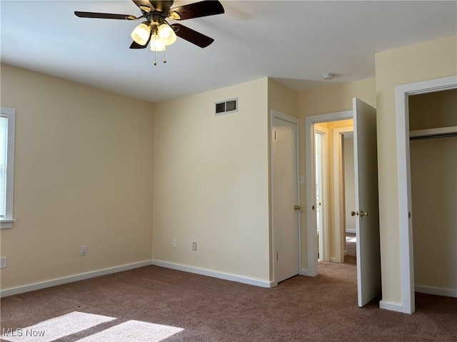 unfurnished bedroom featuring carpet floors and ceiling fan