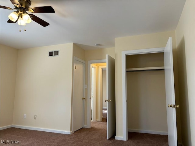 unfurnished bedroom featuring ceiling fan, a closet, and carpet