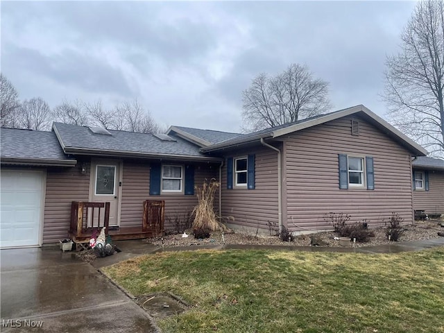 single story home featuring a garage and a front lawn