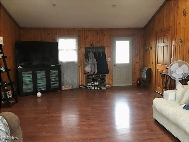 living room with dark hardwood / wood-style flooring, heating unit, wood walls, and vaulted ceiling