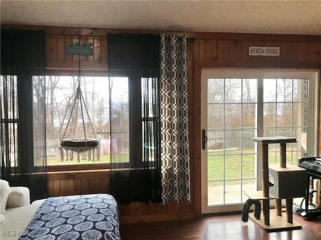 interior space featuring multiple windows and wood walls