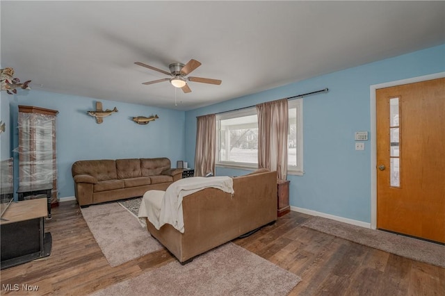 living room featuring wood-type flooring and ceiling fan