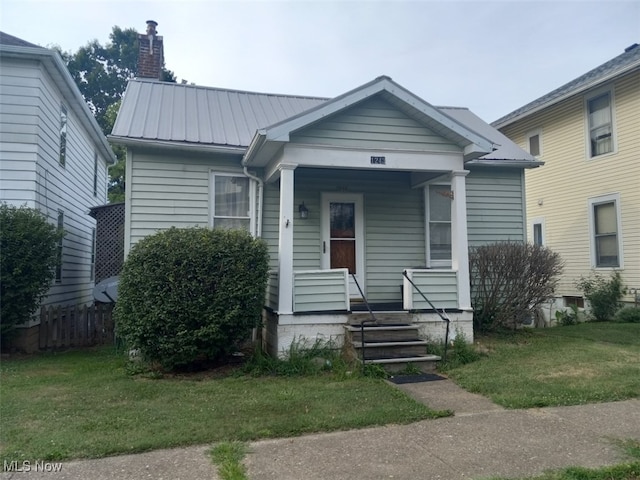 bungalow-style home featuring a front yard and covered porch