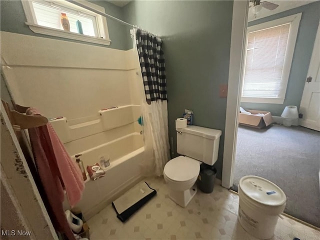 bathroom with shower / tub combo with curtain and toilet