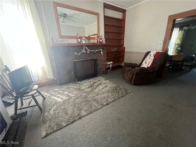 living room featuring crown molding and a fireplace