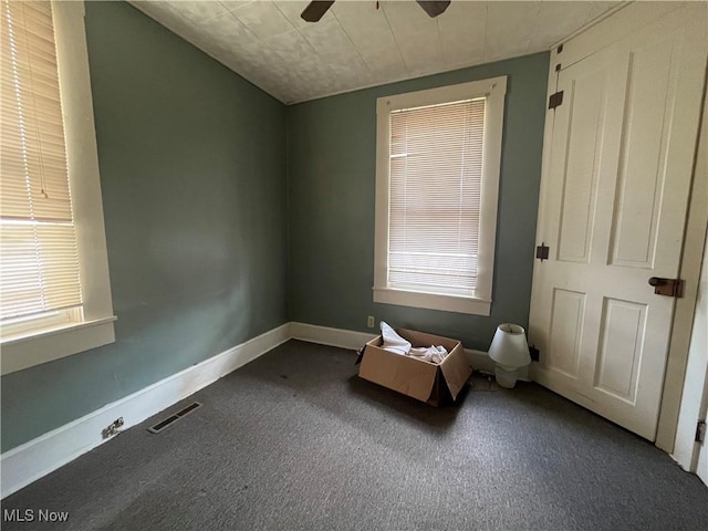 unfurnished bedroom with ceiling fan and carpet