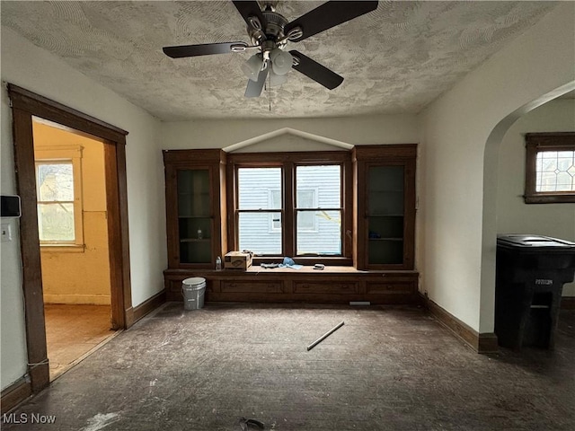 interior space featuring ceiling fan and a textured ceiling