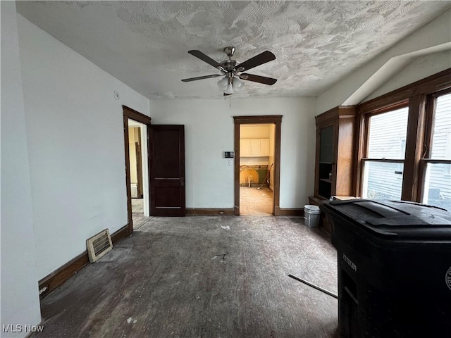 bedroom with ceiling fan and a textured ceiling