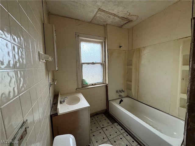 full bathroom with vanity,  shower combination, tile walls, and toilet