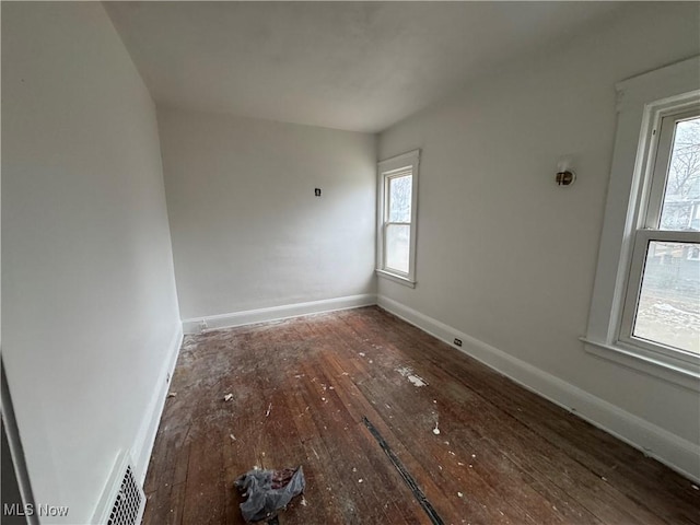 spare room featuring dark hardwood / wood-style floors