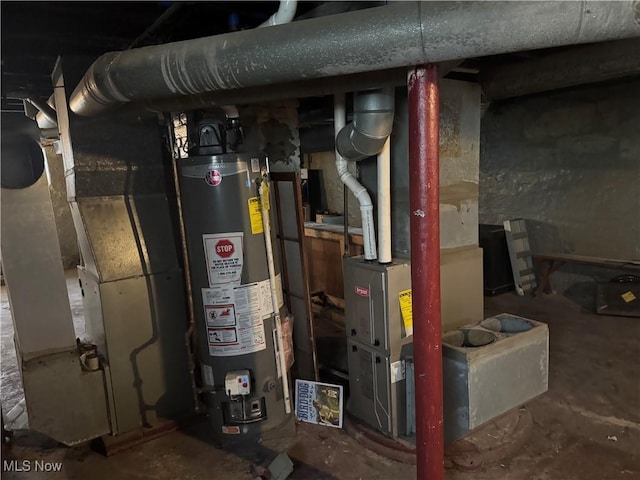 utility room featuring heating unit and gas water heater